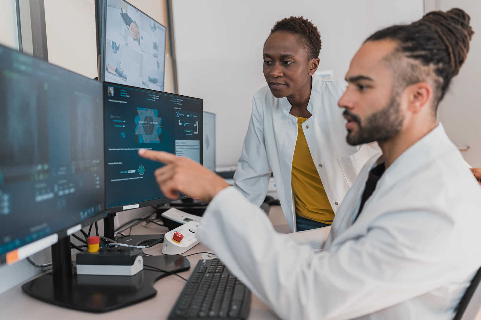 Healthcare professionals reviewing analytics on monitors