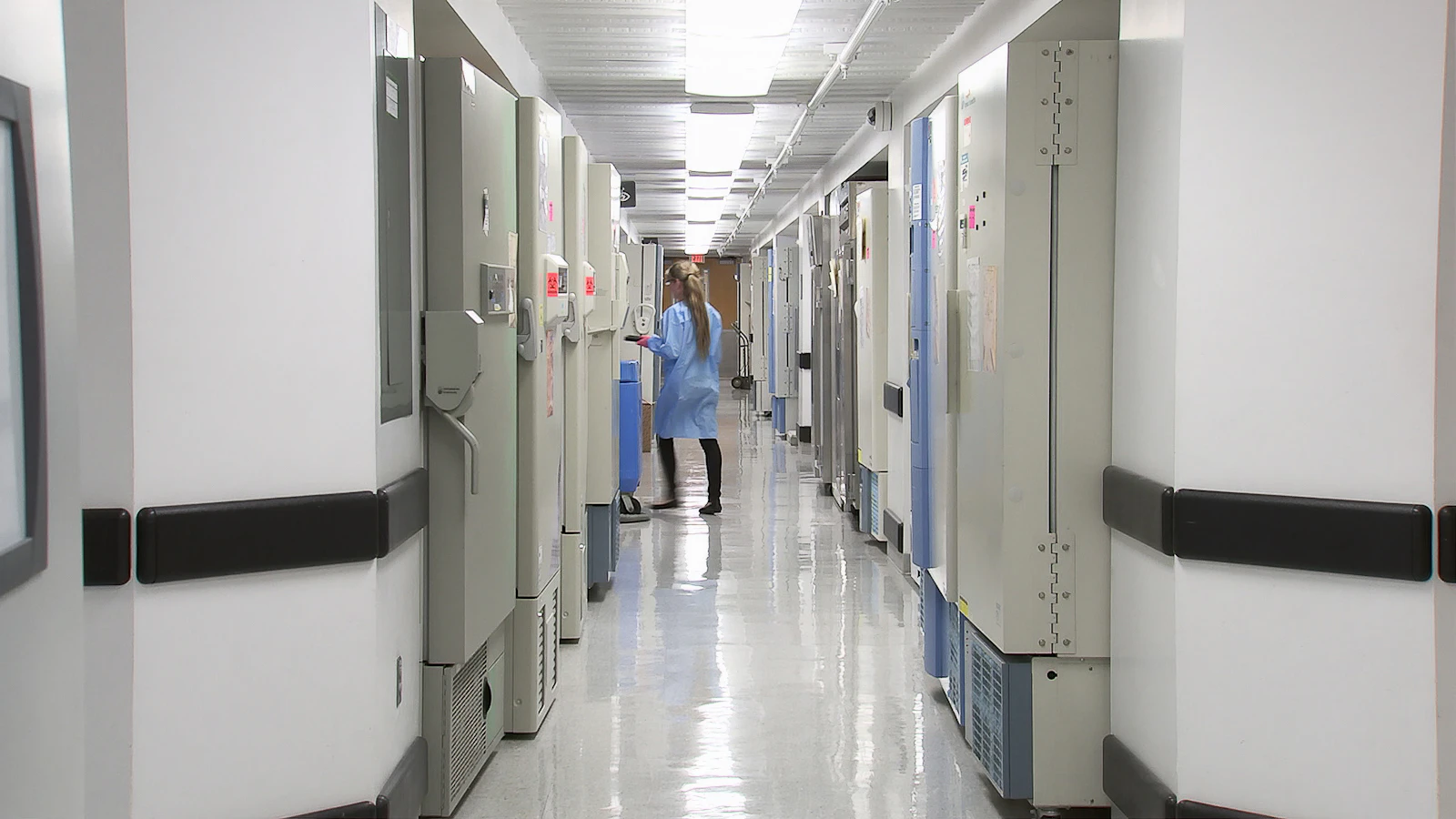 Clinical lab corridor with staff at work